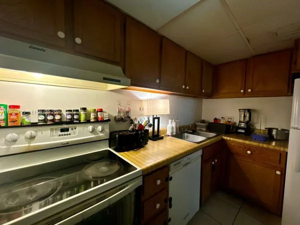 a kitchen with a sink a stove and a refrigerator