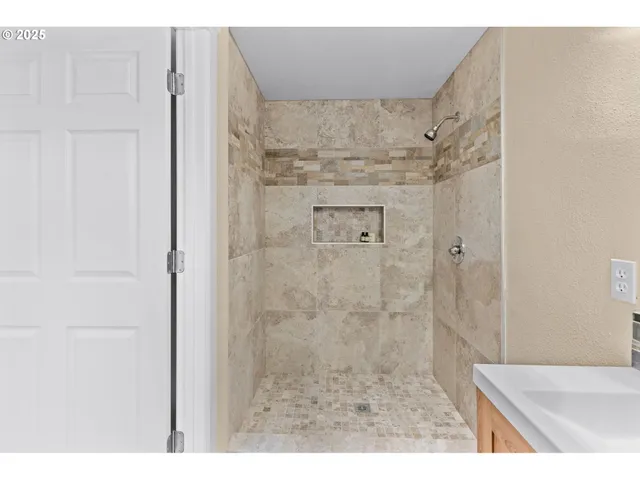 a bathroom with a sink a mirror and a shower