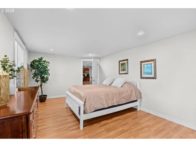 a bedroom with a bed and a view of kitchen