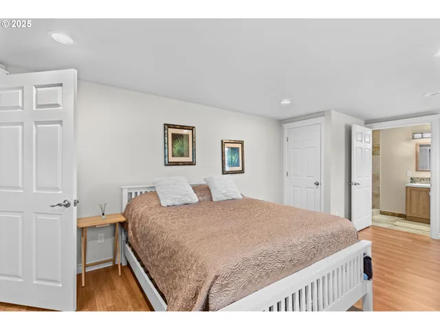 a bedroom with a bed dresser and a window