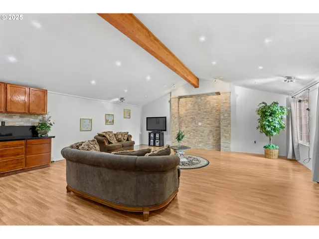 a bathroom with a granite countertop sink a toilet and shower