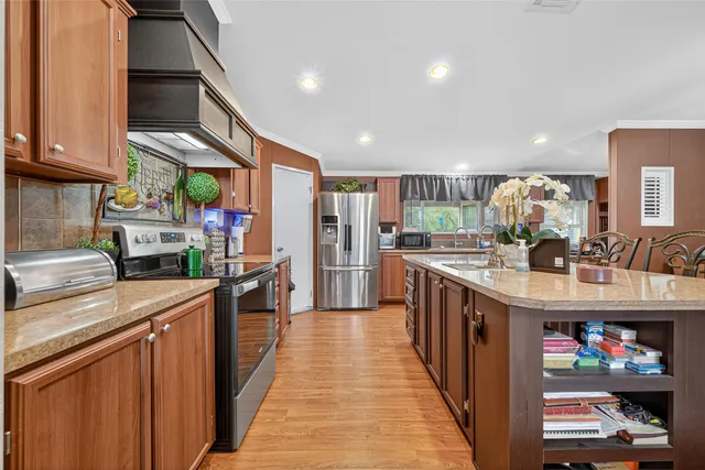 a kitchen with stainless steel appliances granite countertop a stove and cabinets
