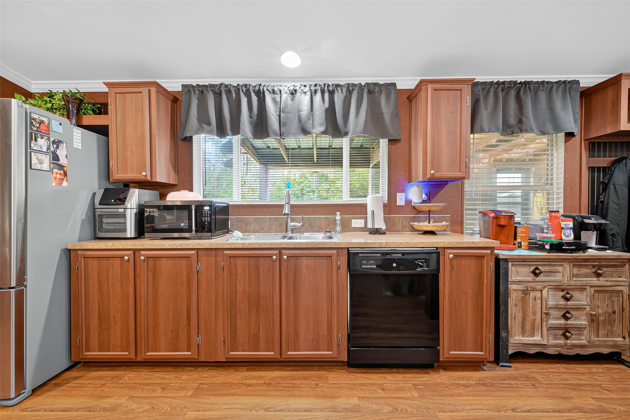 10715 Bozeman Ferry Road Midway, TX 75852 - Photo 14 of 50 a kitchen with stainless steel appliances granite countertop a refrigerator a sink dishwasher a stove and a dining table with wooden floor