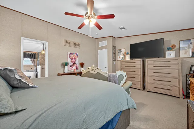 a bedroom with furniture and a flat screen tv