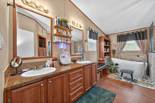 a bathroom with a double vanity sink and a mirror