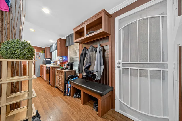 a view of an entryway with wooden floor and stairs