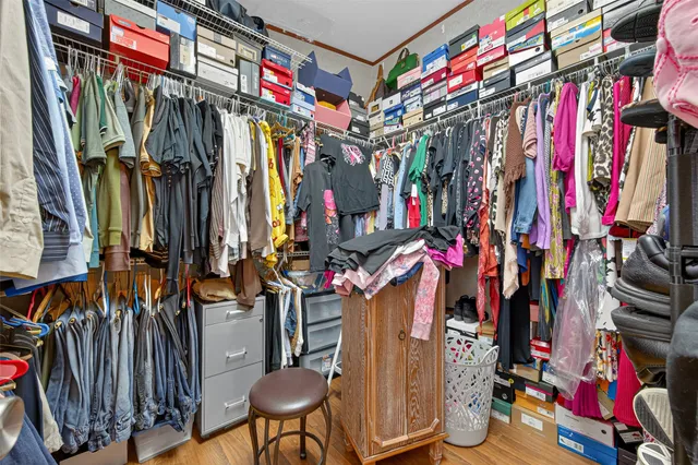 a view of walk in closet with clothes
