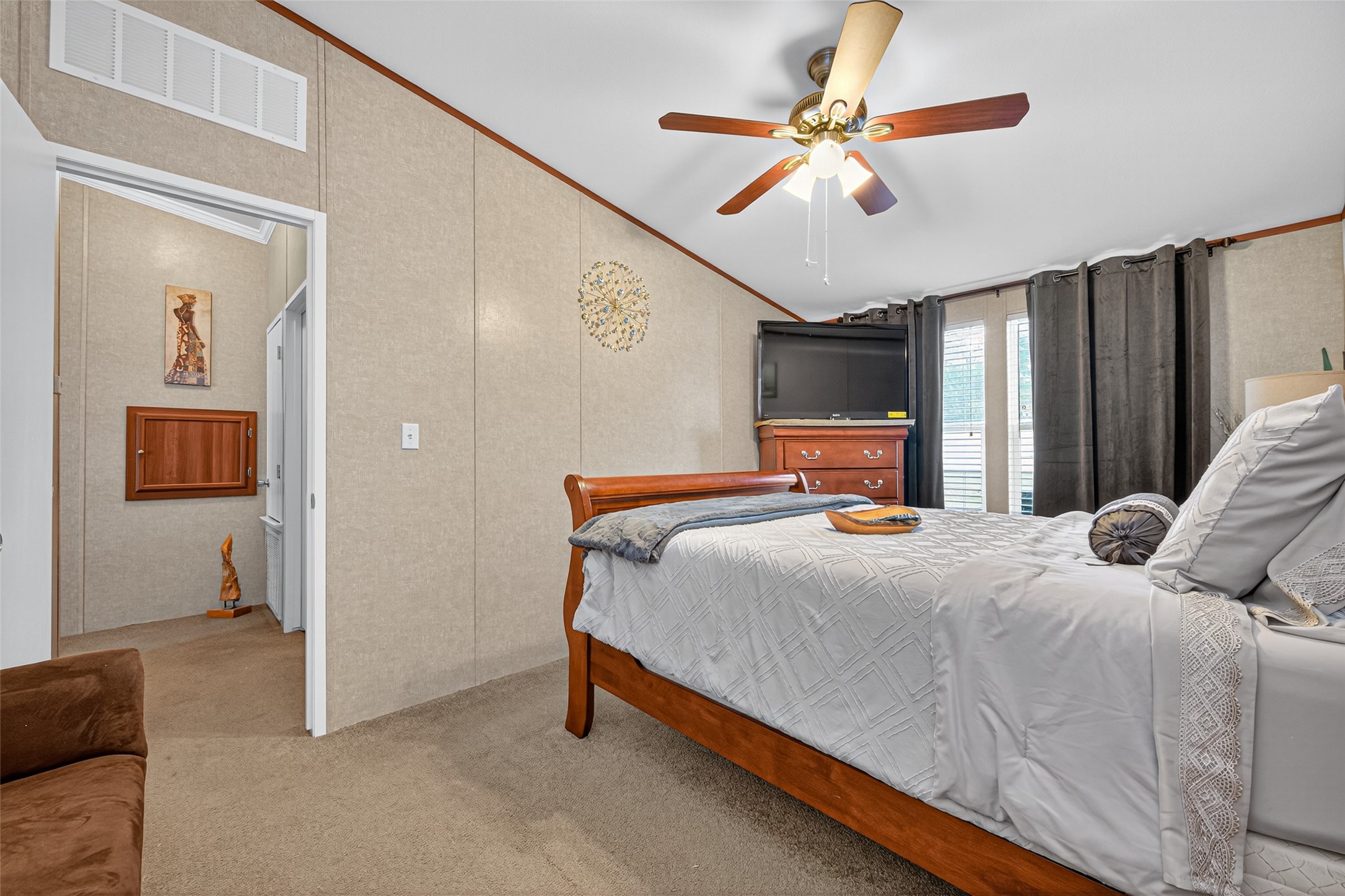 10715 Bozeman Ferry Road Midway, TX 75852 - Photo 29 of 50 a bedroom with a bed and a chandelier