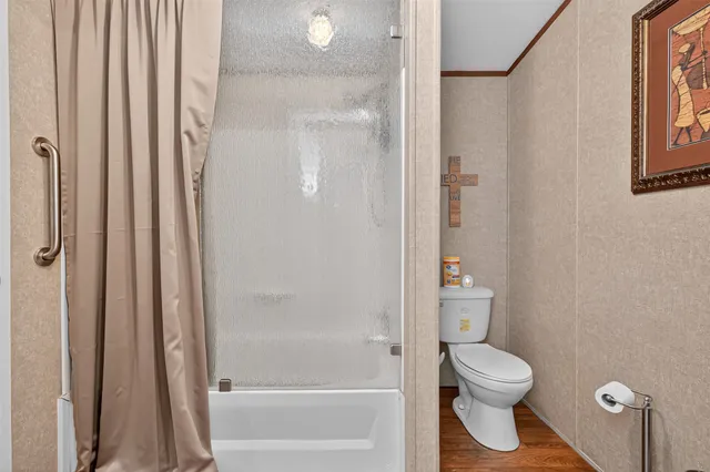 a bathroom with a toilet and shower