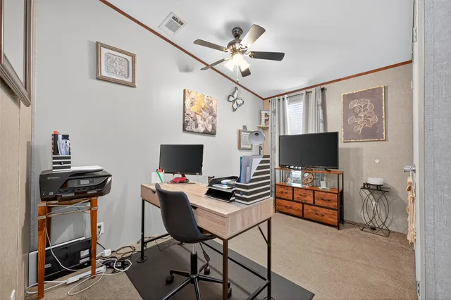 a workspace with furniture and ceiling fan