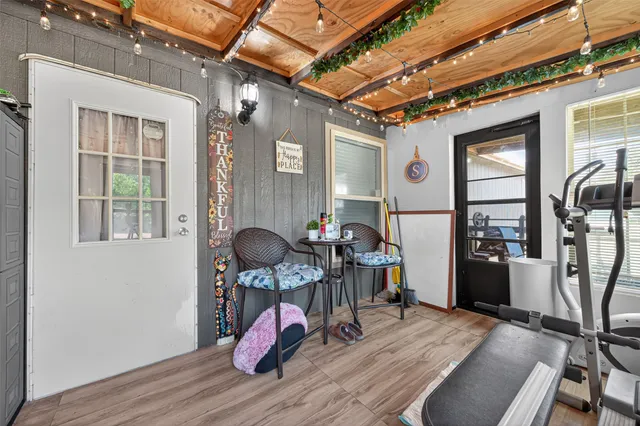 a view of gym equipment with wooden floor