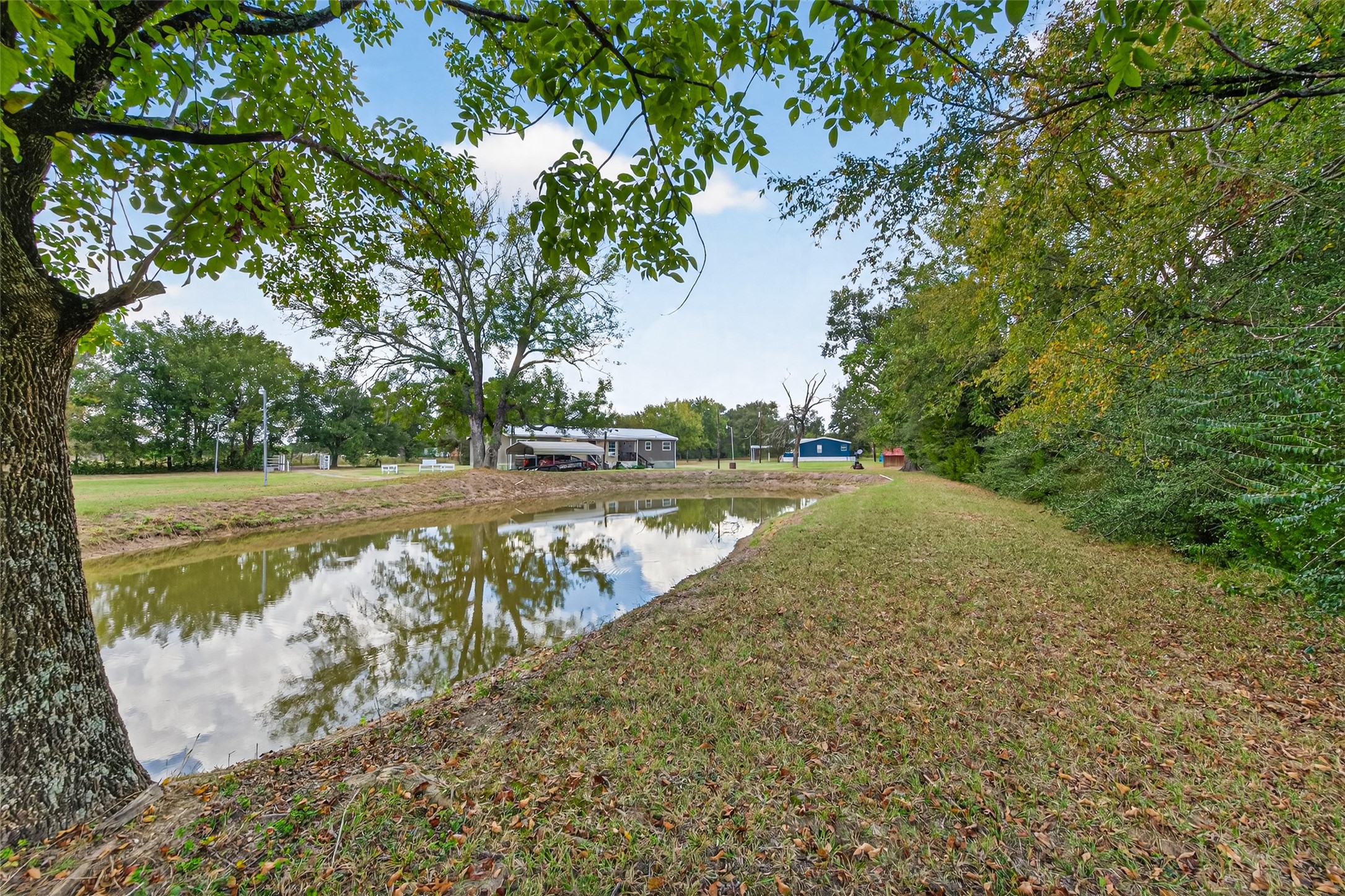 10715 Bozeman Ferry Road Midway, TX 75852 - Photo 42 of 50 a view of a lake with a yard and large trees