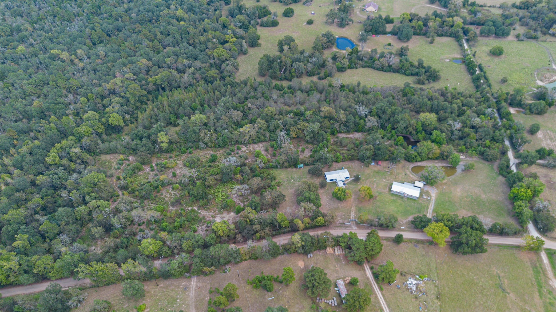 10715 Bozeman Ferry Road Midway, TX 75852 - Photo 47 of 50 an aerial view of residential houses with outdoor space and trees