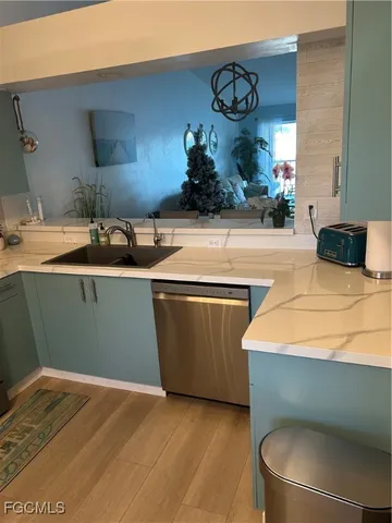 a room with granite countertop a sink and a stove