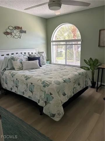 a bedroom with a bed flowerpot and window