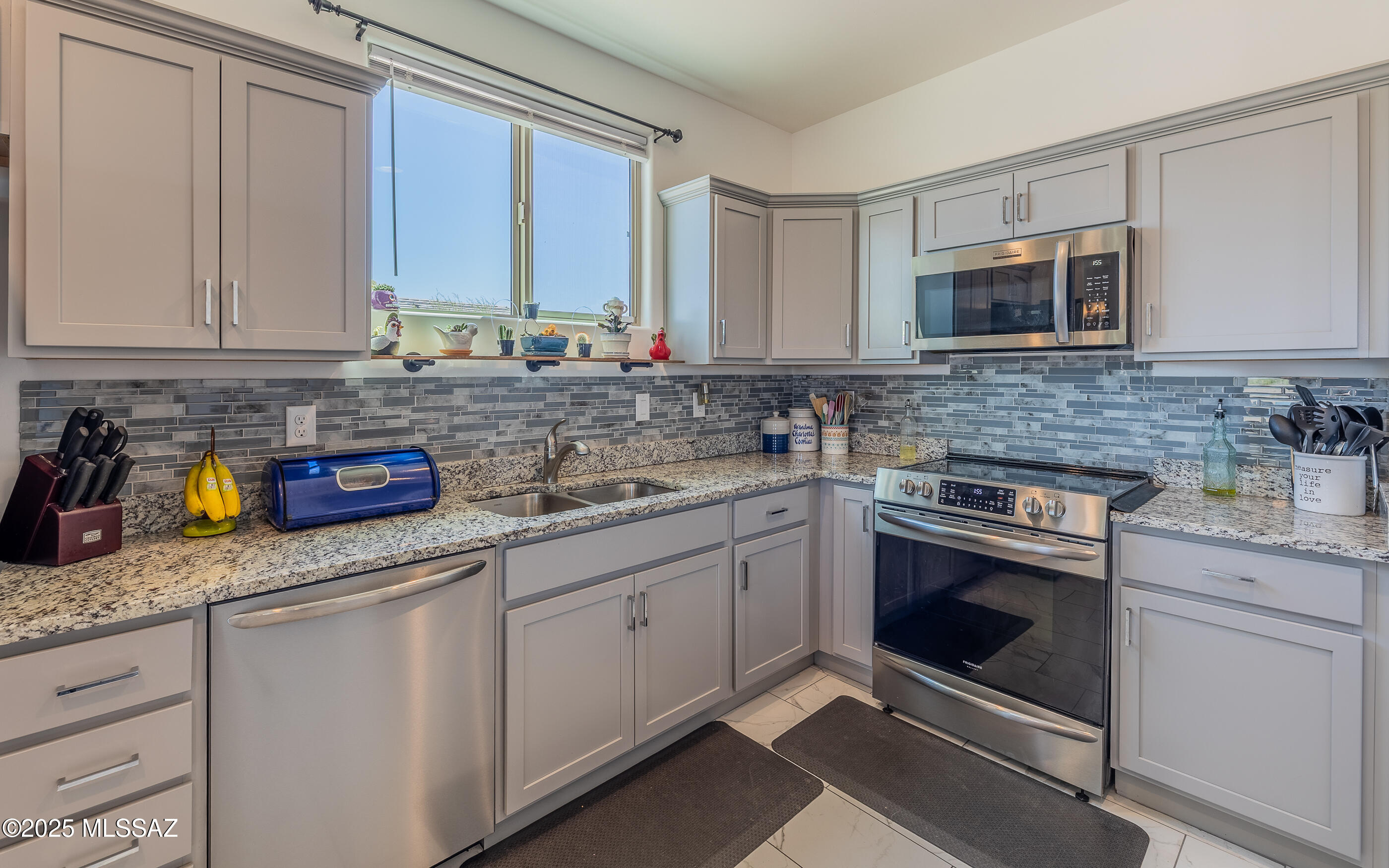 12123 Creosote Valley Road Vail, AZ 85641 - Photo 11 of 46 a kitchen with stainless steel appliances granite countertop a sink stove and cabinets