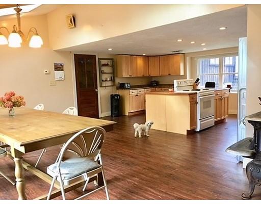 185 Ward Hill Road Phillipston, MA 01331 - Photo 8 of 40 a kitchen with a table chairs refrigerator and cabinets