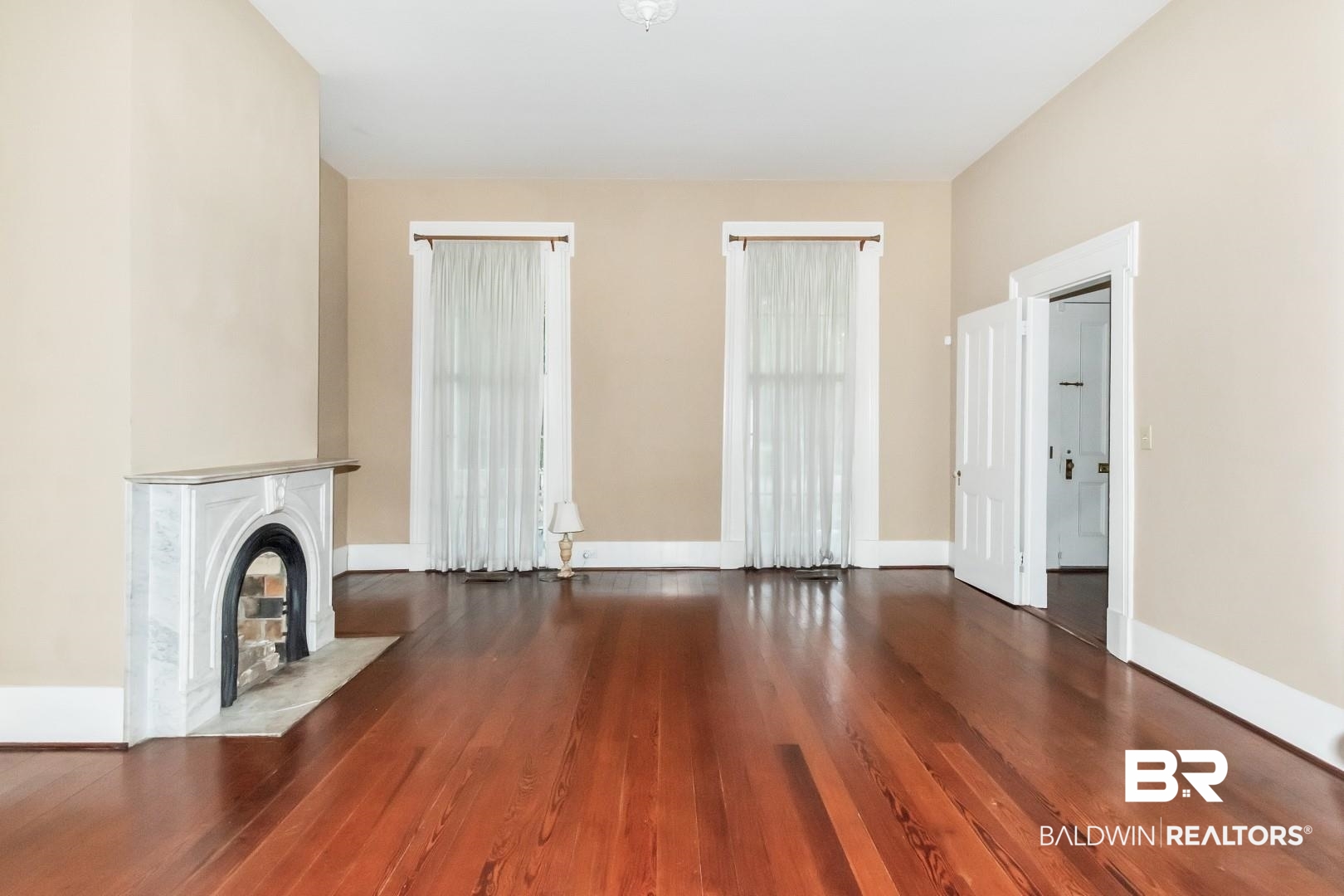 959 Dauphin Street Mobile, AL 36604 - Photo 5 of 43 Unfurnished living room featuring a fireplace and wood-type flooring