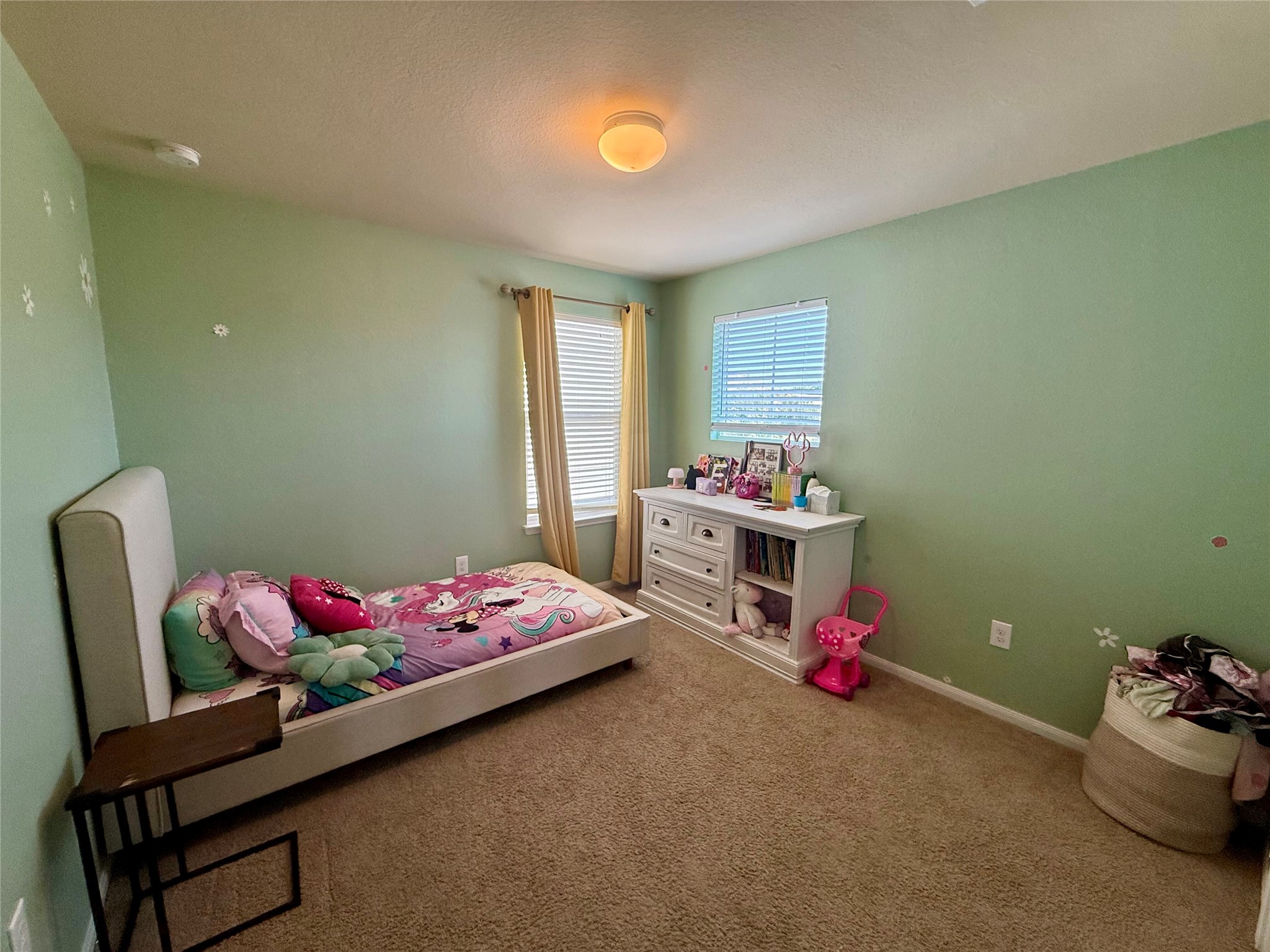 11700 Andesite Road Manor, TX 78653 - Photo 24 of 32 A restful and inviting bedroom space, offering comfort and natural light.