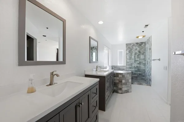 a bath tub sitting in a bathroom next to a window