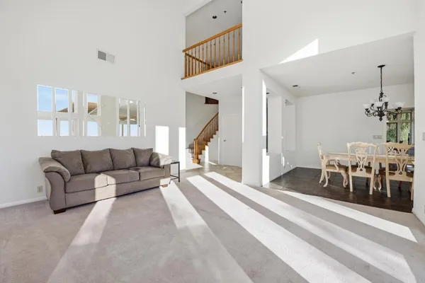 a view of a dining room with furniture large windows and wooden floor