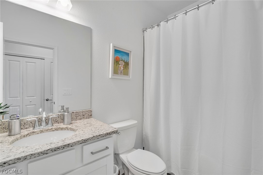 17388 Walnut Run Drive Alva, FL 33920 - Photo 21 of 24 a bathroom with a granite countertop sink and a mirror
