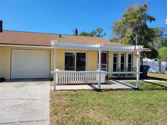 a view of a house with backyard and porch