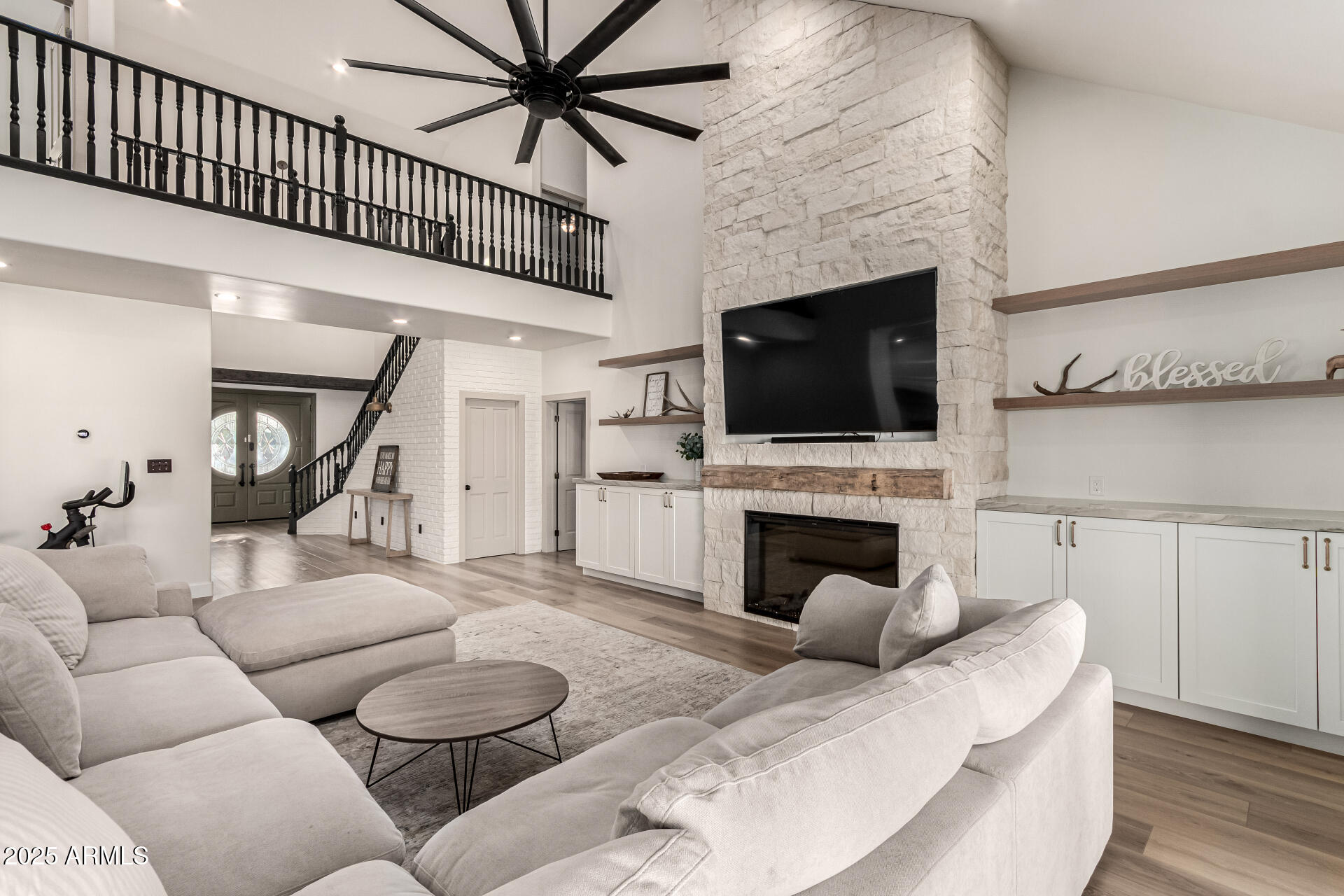 2552 East Ridgewood Lane Gilbert, AZ 85298 - Photo 13 of 80 a living room with furniture a fireplace and a flat screen tv