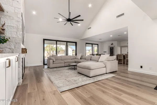 a kitchen with stainless steel appliances white cabinets and a wooden floor