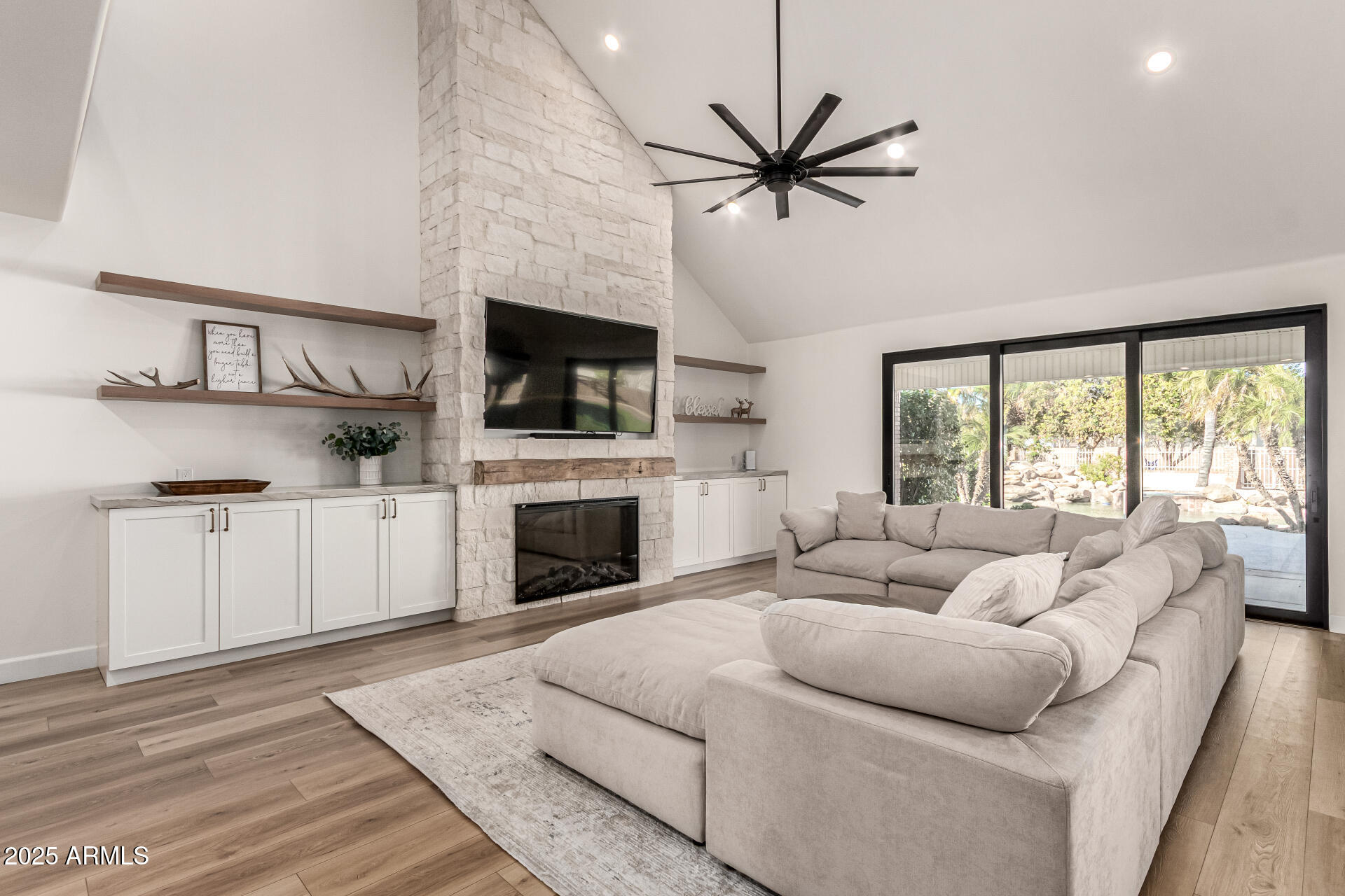 2552 East Ridgewood Lane Gilbert, AZ 85298 - Photo 15 of 80 a living room with furniture a fireplace and a flat screen tv