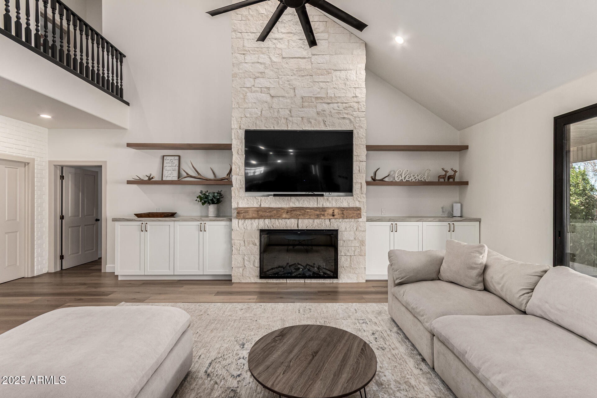 2552 East Ridgewood Lane Gilbert, AZ 85298 - Photo 17 of 80 a living room with furniture a fireplace and a flat screen tv