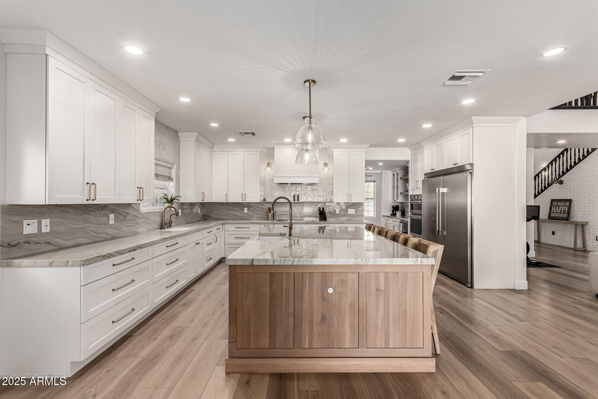 2552 East Ridgewood Lane Gilbert, AZ 85298 - Photo 18 of 80 a large kitchen with stainless steel appliances kitchen island granite countertop a large kitchen island a stove a refrigerator a sink and a cabinets
