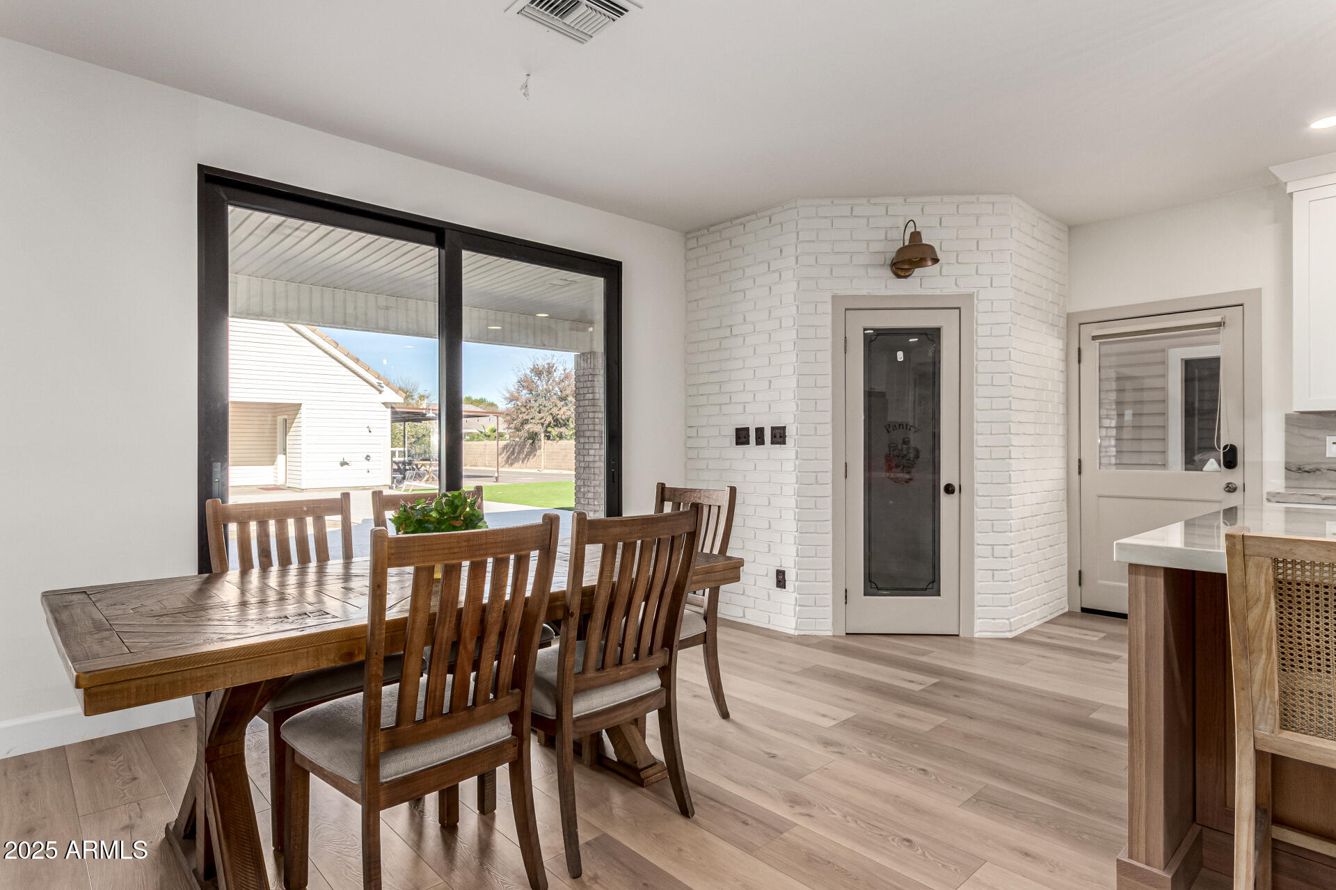 2552 East Ridgewood Lane Gilbert, AZ 85298 - Photo 23 of 80 a view of a dining room with furniture window and wooden floor