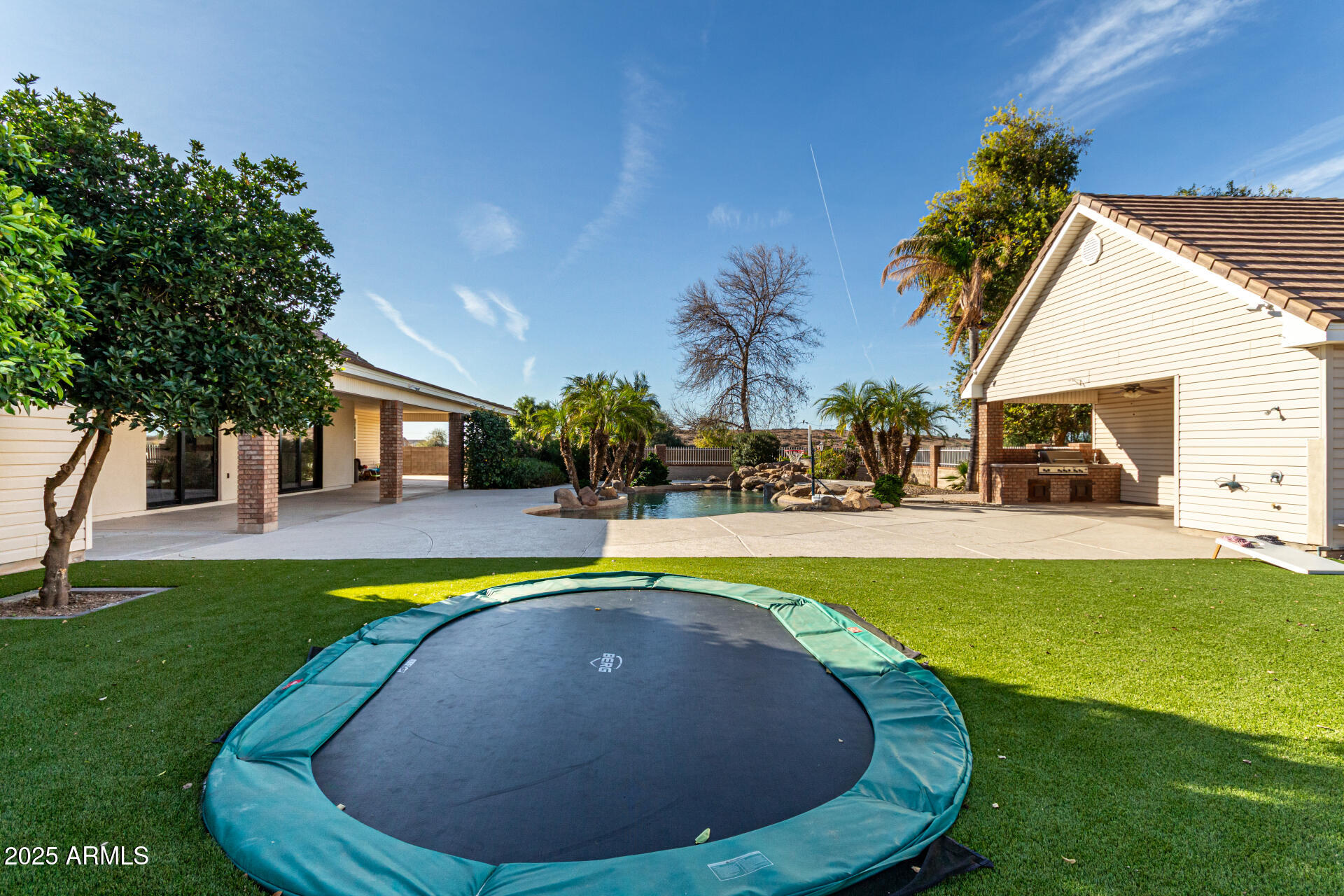 2552 East Ridgewood Lane Gilbert, AZ 85298 - Photo 59 of 80 a view of swimming pool with outdoor seating and house in the background
