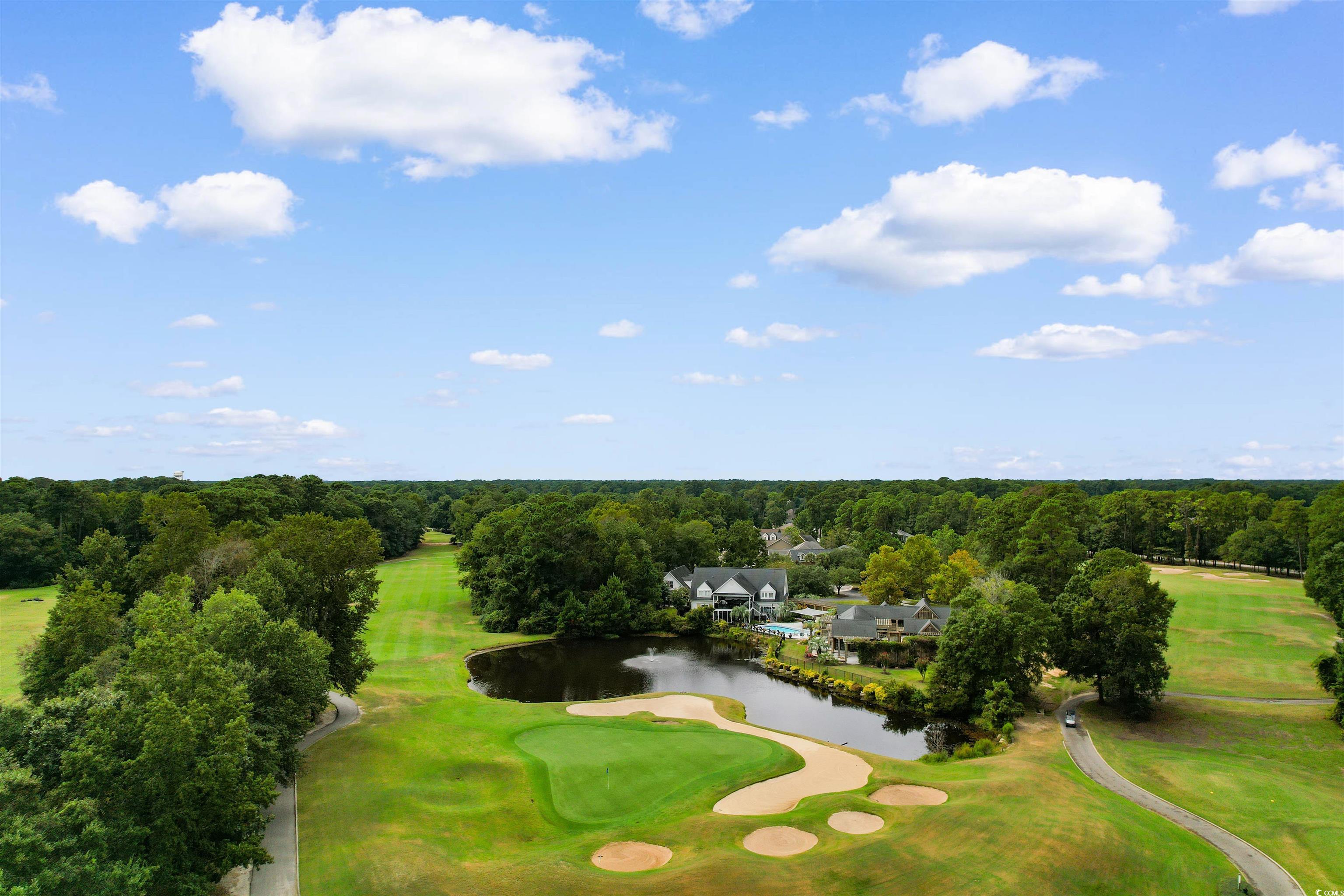 4430 Lady Banks Lane, Unit A2 Murrells Inlet, SC 29576 - Photo 28 of 31 Drone / aerial view of a golf course and a nearby body of water