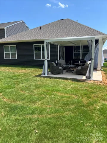 a house view with swimming pool and garden