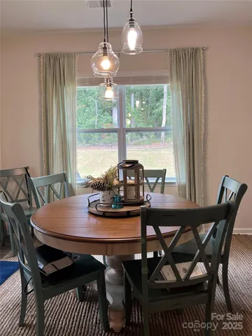 a view of a dining room with furniture window and outside view
