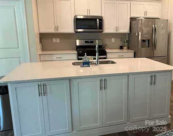 a kitchen with a sink and cabinets