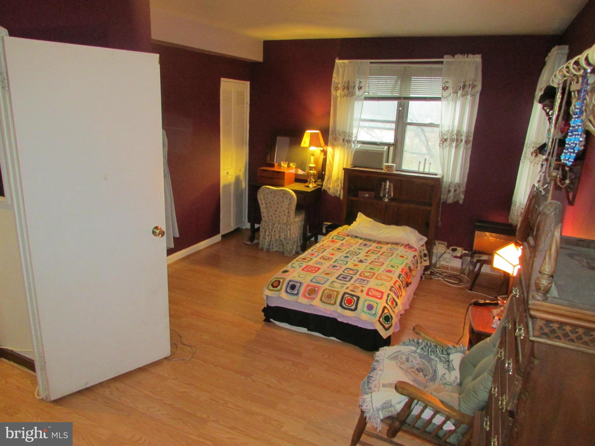 39 Ridge Road, Unit F Greenbelt, MD 20770 - Photo 11 of 14 a bedroom with a bed window and mirror