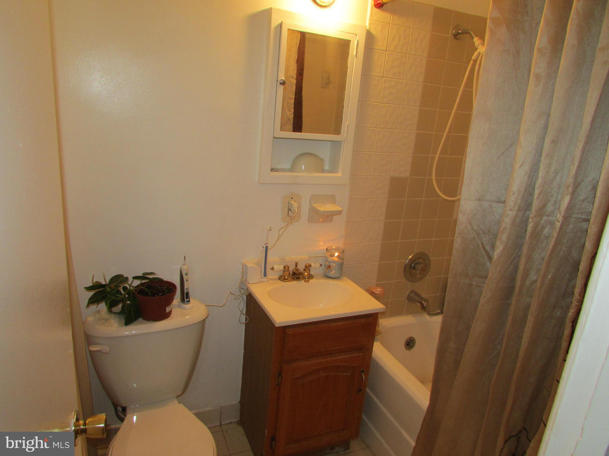 39 Ridge Road, Unit F Greenbelt, MD 20770 - Photo 14 of 14 a bathroom with a sink toilet and a mirror