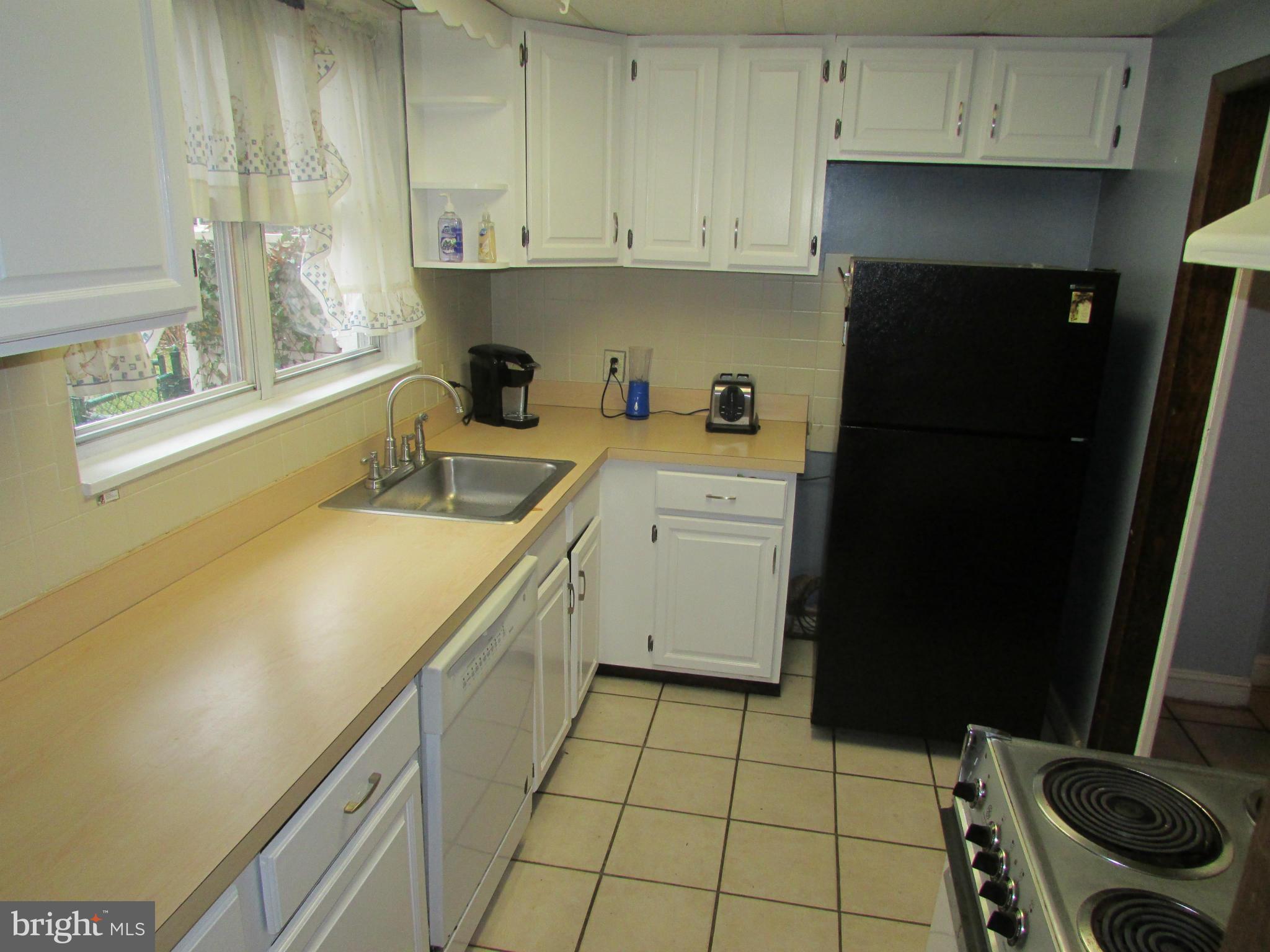 39 Ridge Road, Unit F Greenbelt, MD 20770 - Photo 6 of 14 a kitchen with a sink cabinets and appliances