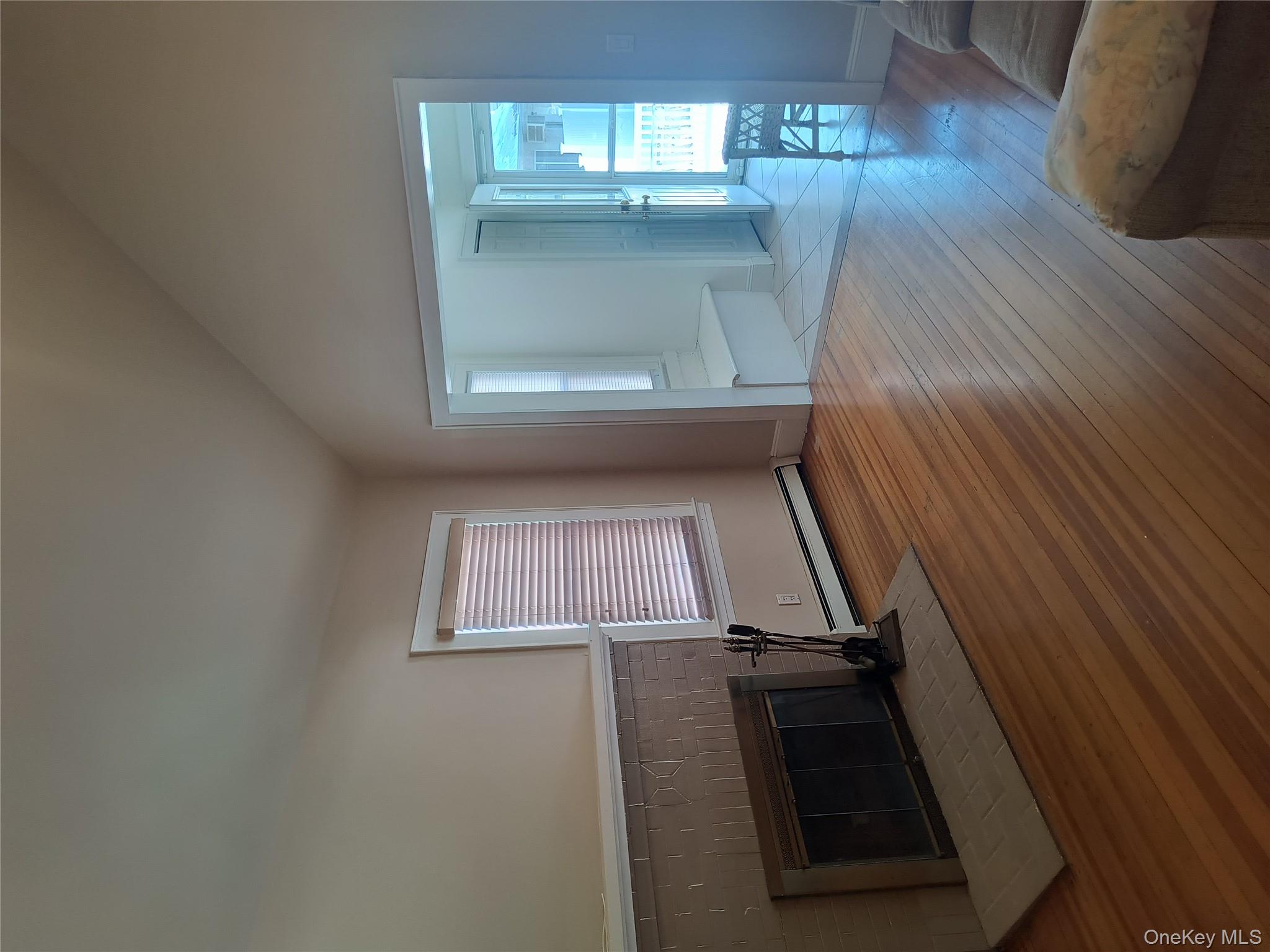 25 July Walk Long Beach, NY 11561 - Photo 9 of 15 living room with hardwood floors and woodburning fireplace