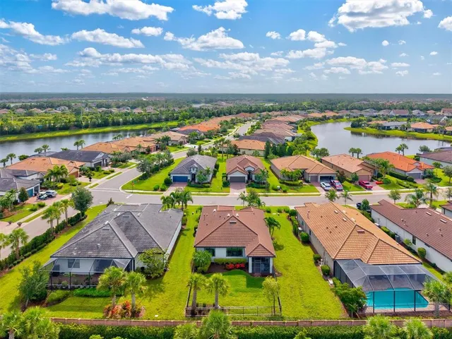 a living room with furniture potted plants and a fireplace