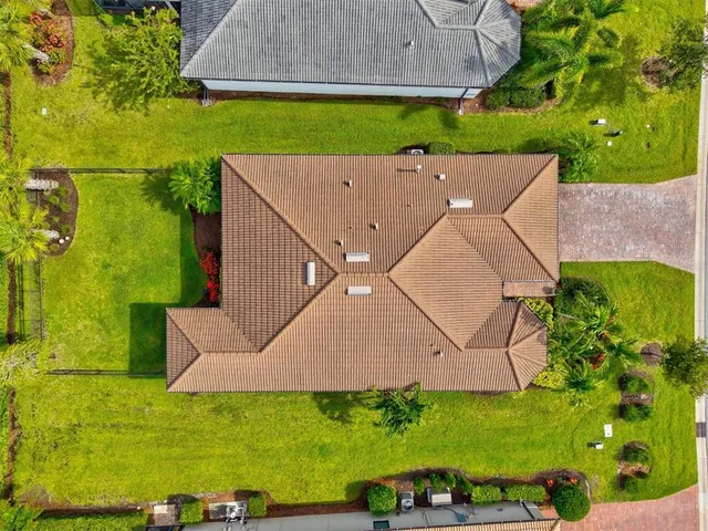 a living room with patio furniture and a large window