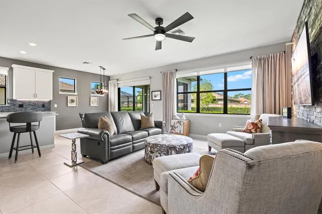 a living room with furniture and large windows