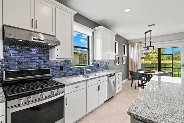 a kitchen with sink stove and cabinets
