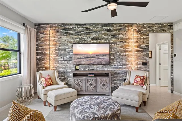 a living room with furniture a large window and a flat screen tv