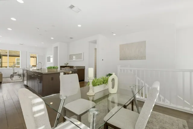 a living room with furniture and kitchen view