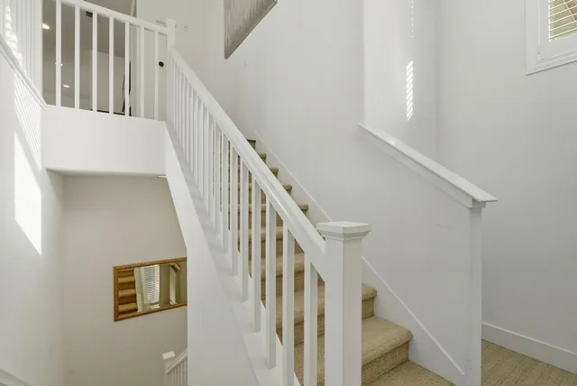 a view of kitchen with stainless steel appliances dining table chairs and wooden floor