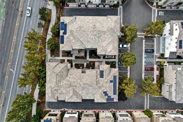 an aerial view of a house with a yard and lake view